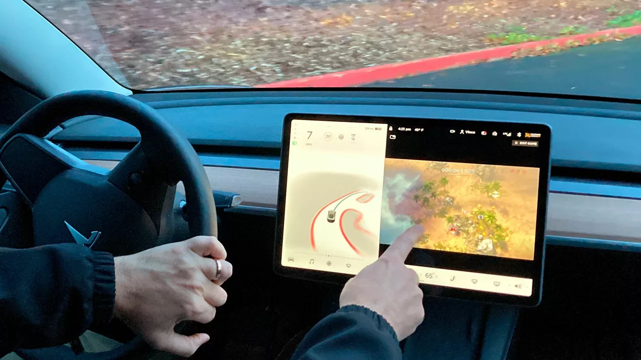 Is Tesla under investigation for letting drivers play video games?